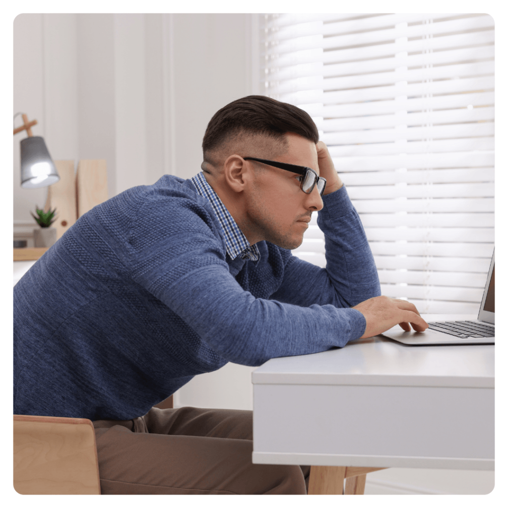 Person experiencing lower back pain at home with highlighted area of spinal discomfort